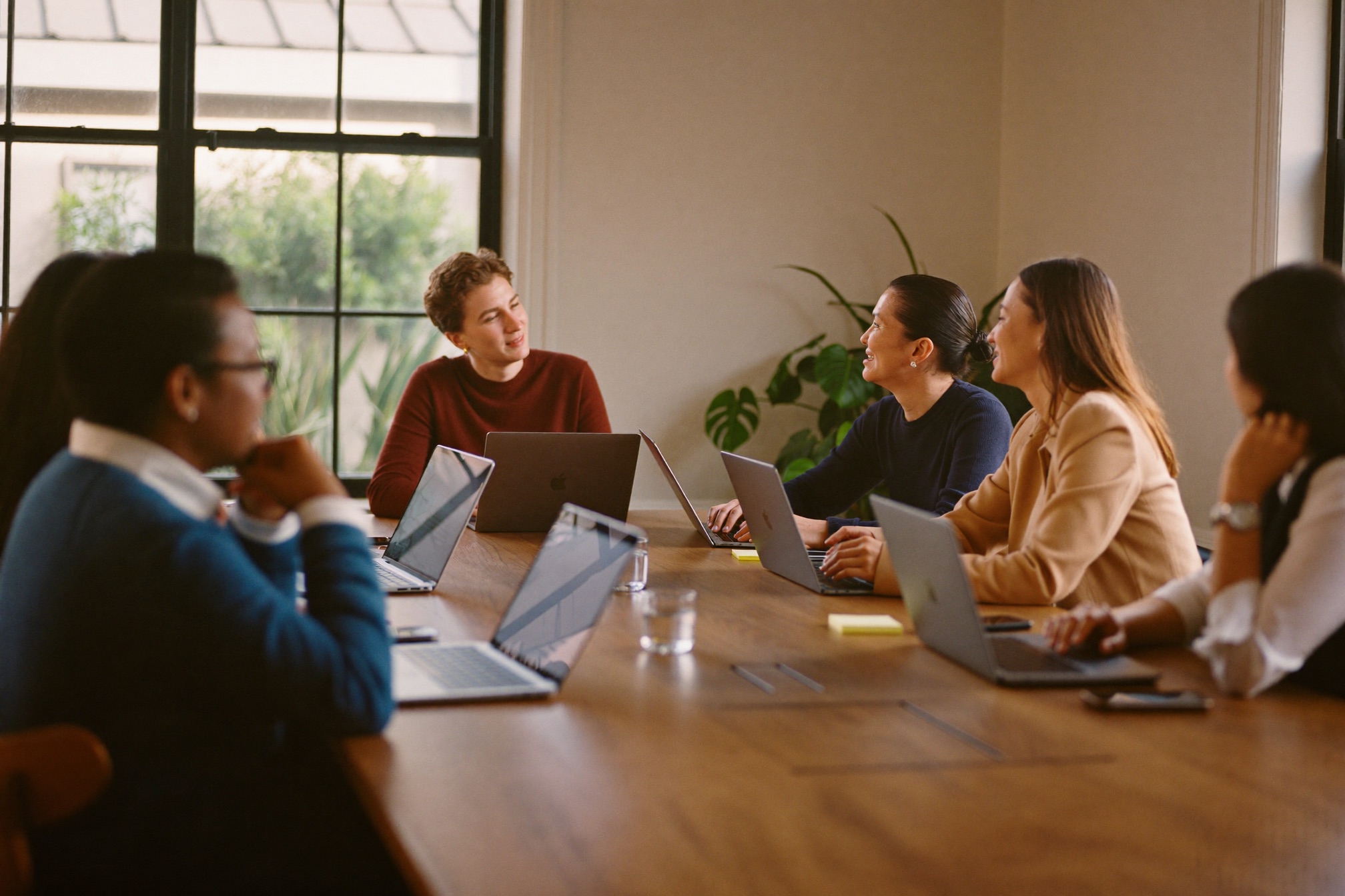 Six professionals learning together around a warm wooden table
